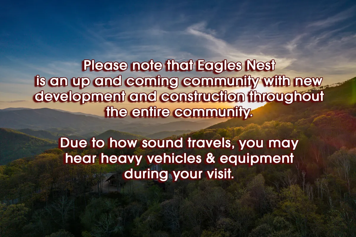 A breathtaking mountain range is visible beneath a vibrant sunset sky, surrounded by lush greenery. The open landscape invites exploration and community activities, reflecting the spirit of Eagles Nest amenities and outdoor adventures.